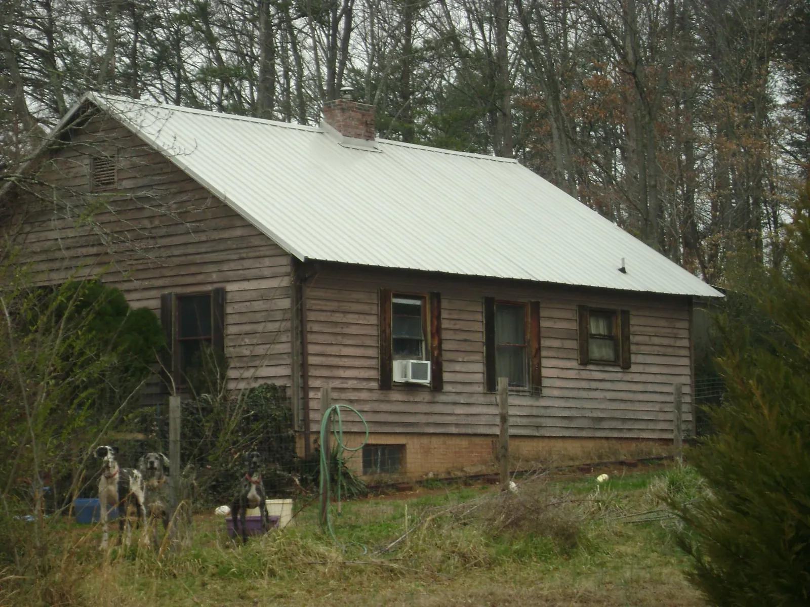 White metal roof on an old wood sided farmhouse, from a Metal Roof Installation job in Wareham